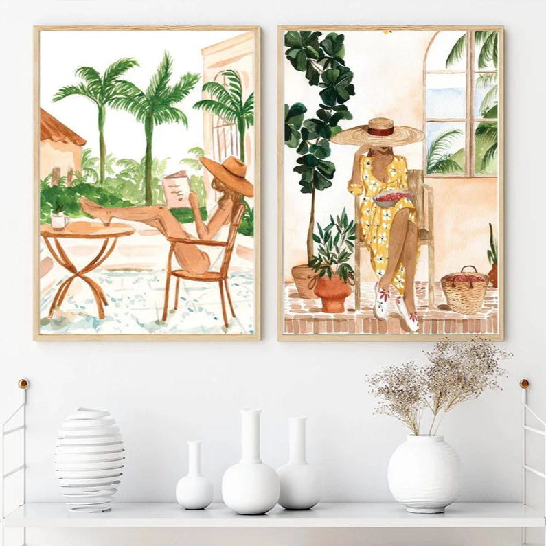 Painting by numbers framed artworks of chic leisure scenes and tropical settings, displayed on a wall above a white shelf with decorative items.
